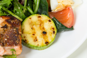 Grilled salmon salad with vegetables and eggs.