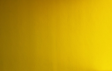 Yellow concrete stucco wall useful for backgrounds or textures