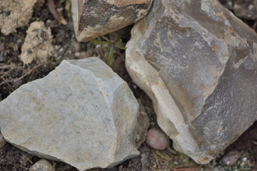 Big stones lie on the ground close up