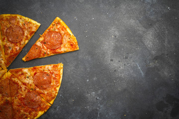 Italian pizza pepperoni on dark stone background
