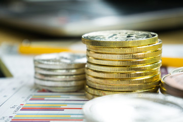 bitcoin are stacked on a background of business graphs