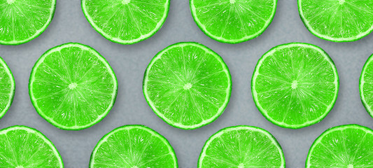 Fototapeta na wymiar Sliced juicy lime on a gray background. Fresh fruits. Fruit background. Summer party. Birthday.