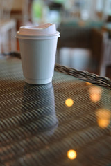 take away cup for hot coffee drink put on glass table in cafe shop