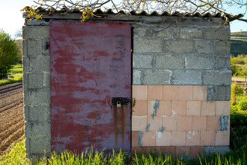 Old cabin made of stones secured with a padlock