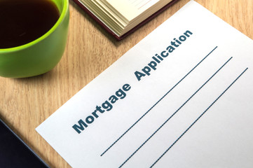 A mortgage application template to fill out with pen and coffee.