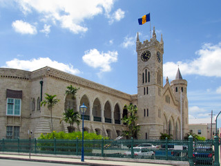 The old historic building is a fortress with a tower and clock. The Parliament Building Of Barbados. Little Big Ben. The capital of Barbados is Bridgetown, Caribbean. - obrazy, fototapety, plakaty