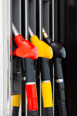 Close-up fuel nozzles on petrol and diesel fuel. Gas station pump. Man refueling gasoline with fuel...