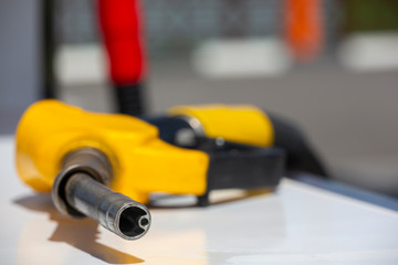 Gasoline pistol pump fuel nozzle Gas station pump. Man refueling gasoline with fuel in a car,...