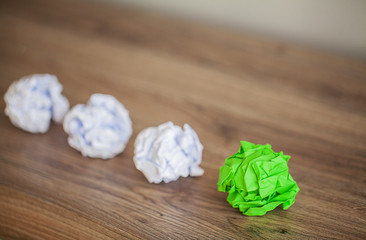 Great idea concept. Crumpled colorful paper on wooden table