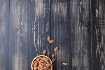 close up of almond on wooden plate