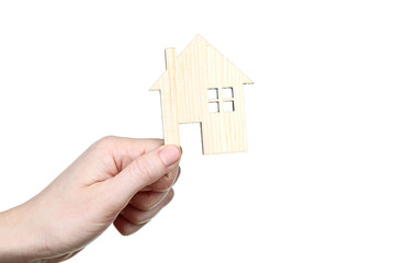 Fototapeta na wymiar Female hand holding wooden house model on white background