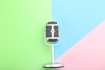 Vintage microphone on colorful background