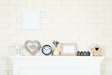 White fireplace with photo frame, round clock and nesting box