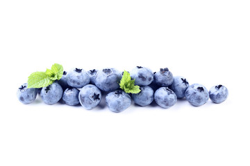 Ripe blueberries with green leafs isolated on white background