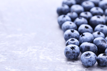 Ripe blueberries on grey background