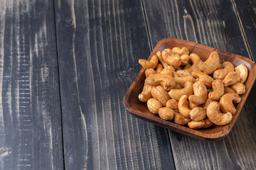 close up of Cashew nut on wooden bowl
