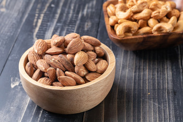 almond and Cashew nut on wooden bowl