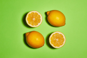 Lemon on green background. Flat lay, top view, copy space . Food concept.