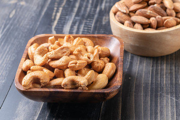 almond and Cashew nut on wooden bowl