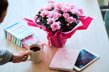 Cozy workspace with beautiful pink flowers