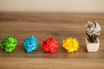 Great idea concept. Crumpled colorful paper on wooden table
