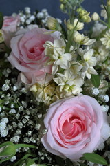 A large bouquet of different flowers. Several types of roses and other plants to decorate the bouquet.