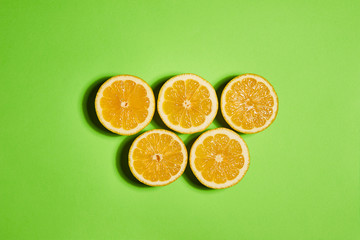 Lemon on green background. Flat lay, top view, copy space . Food concept.