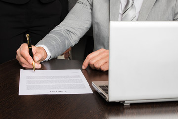 Businessman singing contract document