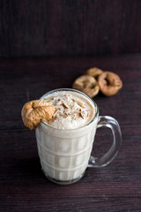 Anjeer milk shake or dried fig milk shake with almonds - selective focus