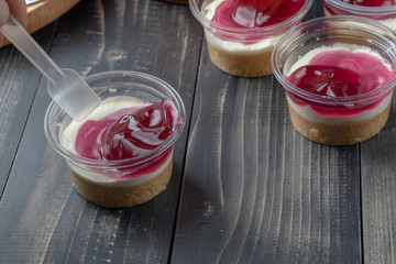 cake with strawberry jelly on plastic cup