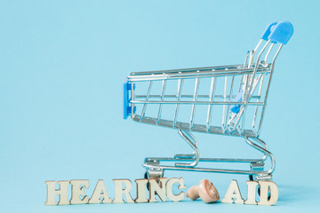 Hearing aid on blue background. Medical, pharmacy and healthcare concept. Copy space. Empty place...