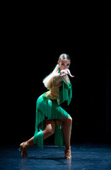 young beautiful female dancer posing on black background