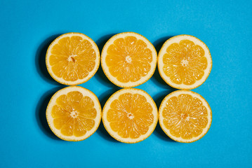 Lemon on blue background. Flat lay, top view, copy space . Food concept.