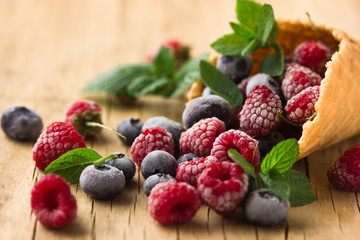 Colorful fruit and berry in waffle cone , summer concept