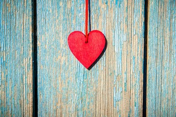 A symbol of love on blue wooden background