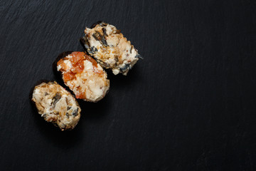 Juicy Gunkan Maki Sushi on black slate