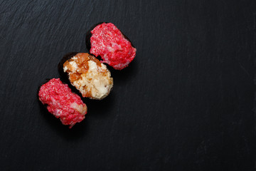 Juicy Gunkan Maki Sushi on black slate