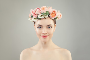 Beauty portrait of young model woman with clear skin and flowers