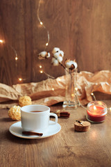 cup of coffee on a wooden background, set in warm brown tones