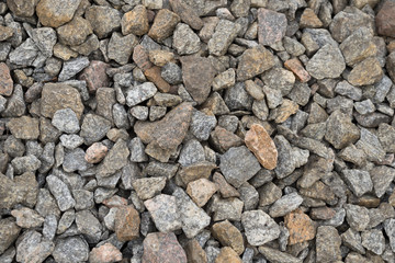 Multi-colored stones on the ground. Different shapes and sizes