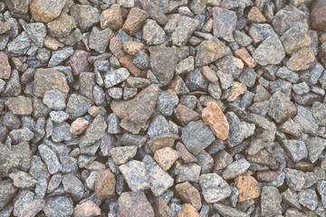Multi-colored stones on the ground. Different shapes and sizes