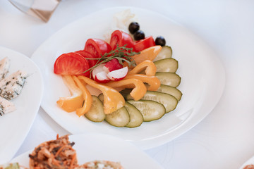 slices of fresh vegetables on the festival table .