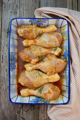 Uncooked marinated chicken legs with spices, ready to be cooked.