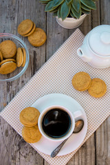 Cup of coffee with sweet cookies, ginger bread. Abstract breakfast image. Rustick wooden background.