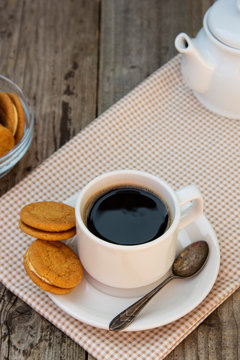 Cup of coffee with sweet cookies, ginger bread. Abstract breakfast image. Rustick wooden background.