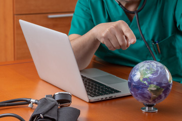 surgeon pointing at the earth globe as a patient that requires some drastic care