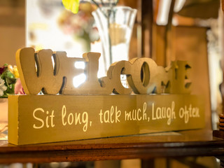 Welcome Sit Long, Talk Much, Laugh Often