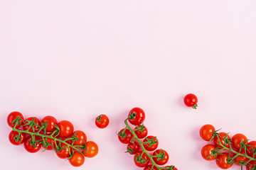 Isolated fresh red cherry tomatoes on pink background. Top view. Flat lay