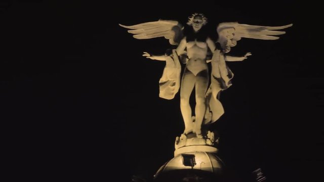 MADRID, SPAIN - JANUARY 17, 2018: Statue of Winged Victory located on the top of Metropolis Building. View against black night sky