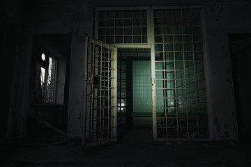 Old abandoned prison cell in the dark